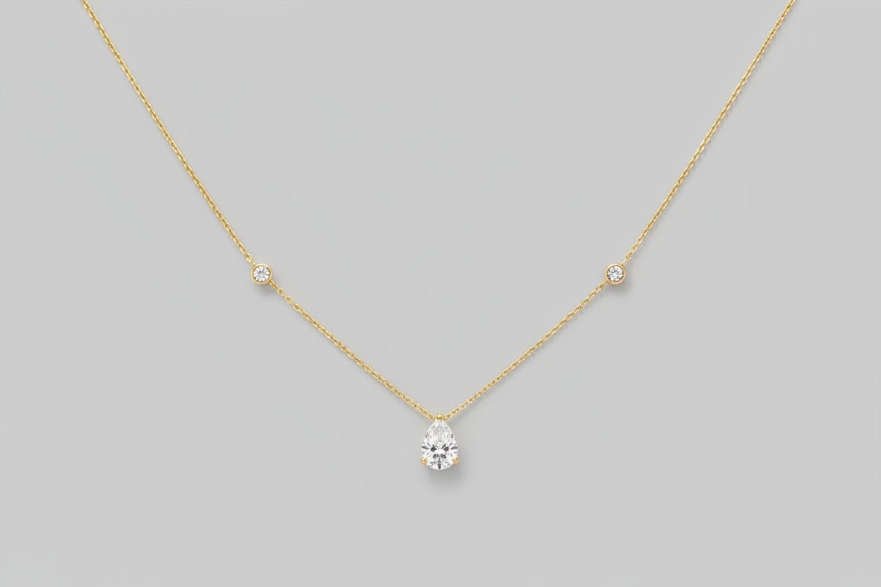 A brilliant 1.25-carat teardrop-shaped moissanite pendant on an 18K gold-plated 925 sterling silver chain