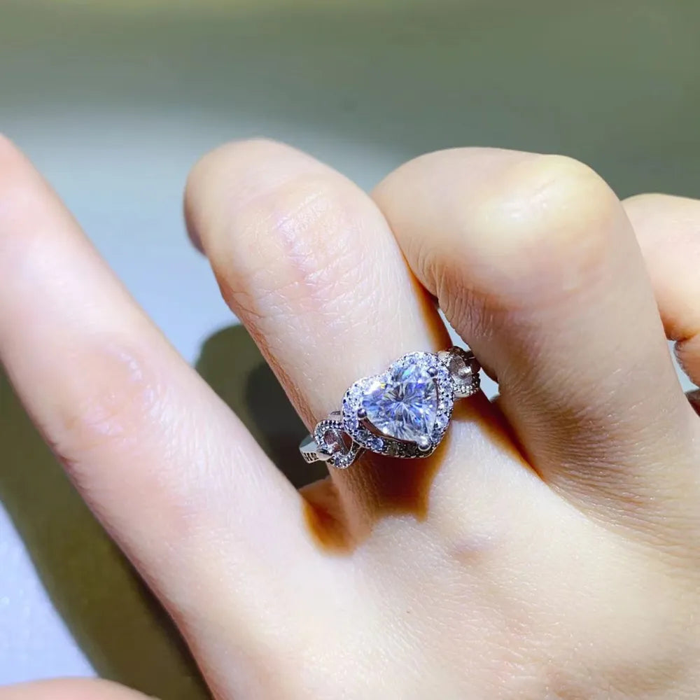 A 1 carat round brilliant moissanite stone set in a polished 925 sterling silver