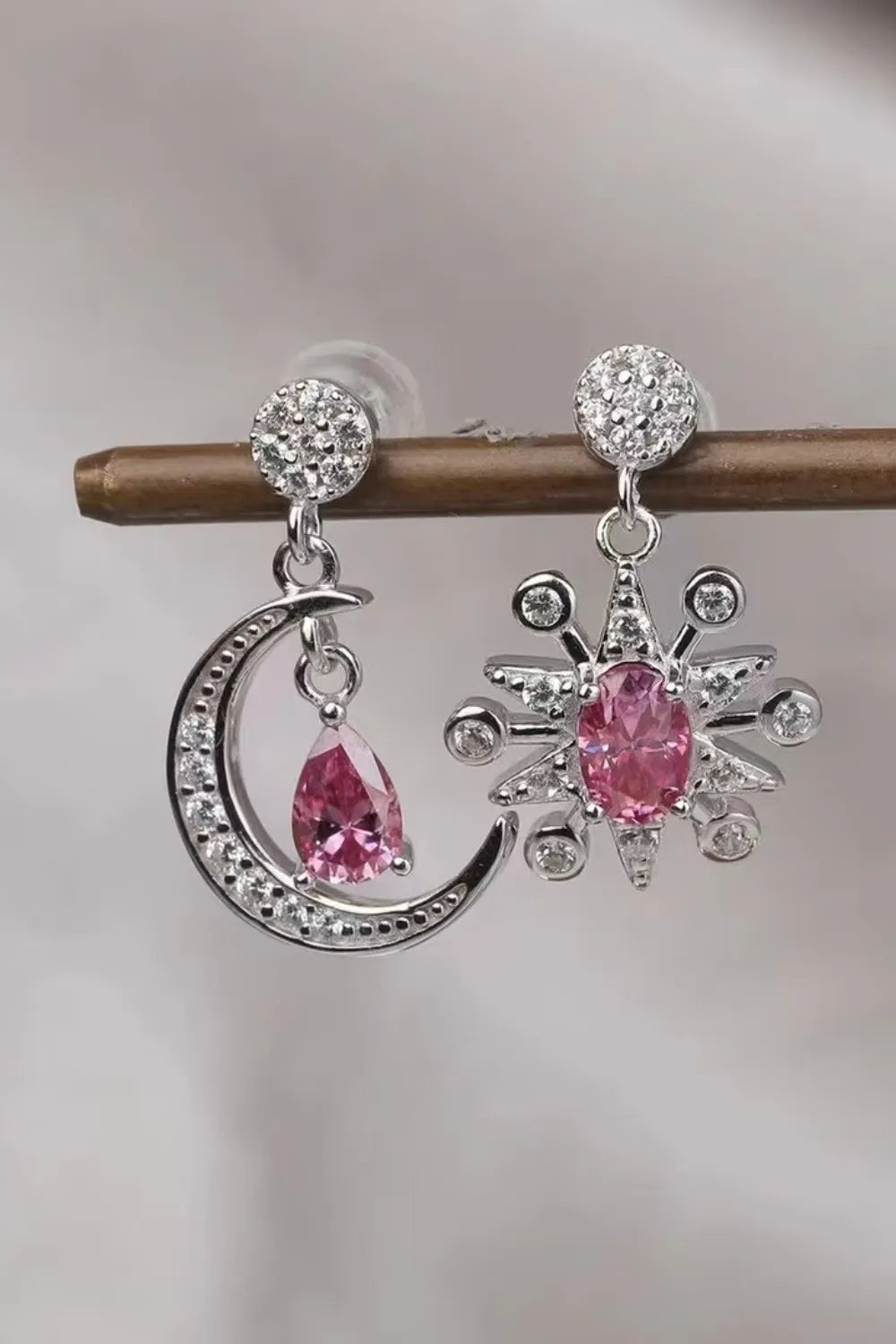 A pair of 1-carat total weight moissanite moon and star earrings in platinum-plated 925 sterling silver.