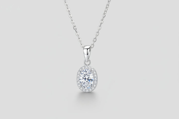 A 1-carat round moissanite pendant on a rhodium-plated 925 sterling silver chain.