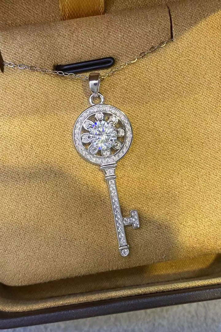 A brilliant 1-carat moissanite key pendant with zircon accents on a platinum-plated 925 sterling silver chain.