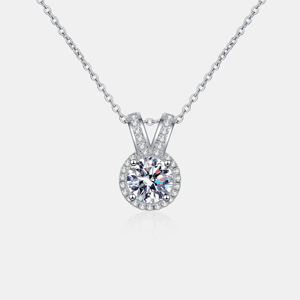 1-carat round cut moissanite pendant with rabbit ear setting in 925 sterling silver.