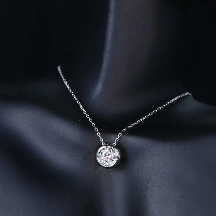 A brilliant 1-carat D Color VVS1 round moissanite pendant on a gold-plated 925 sterling silver chain.