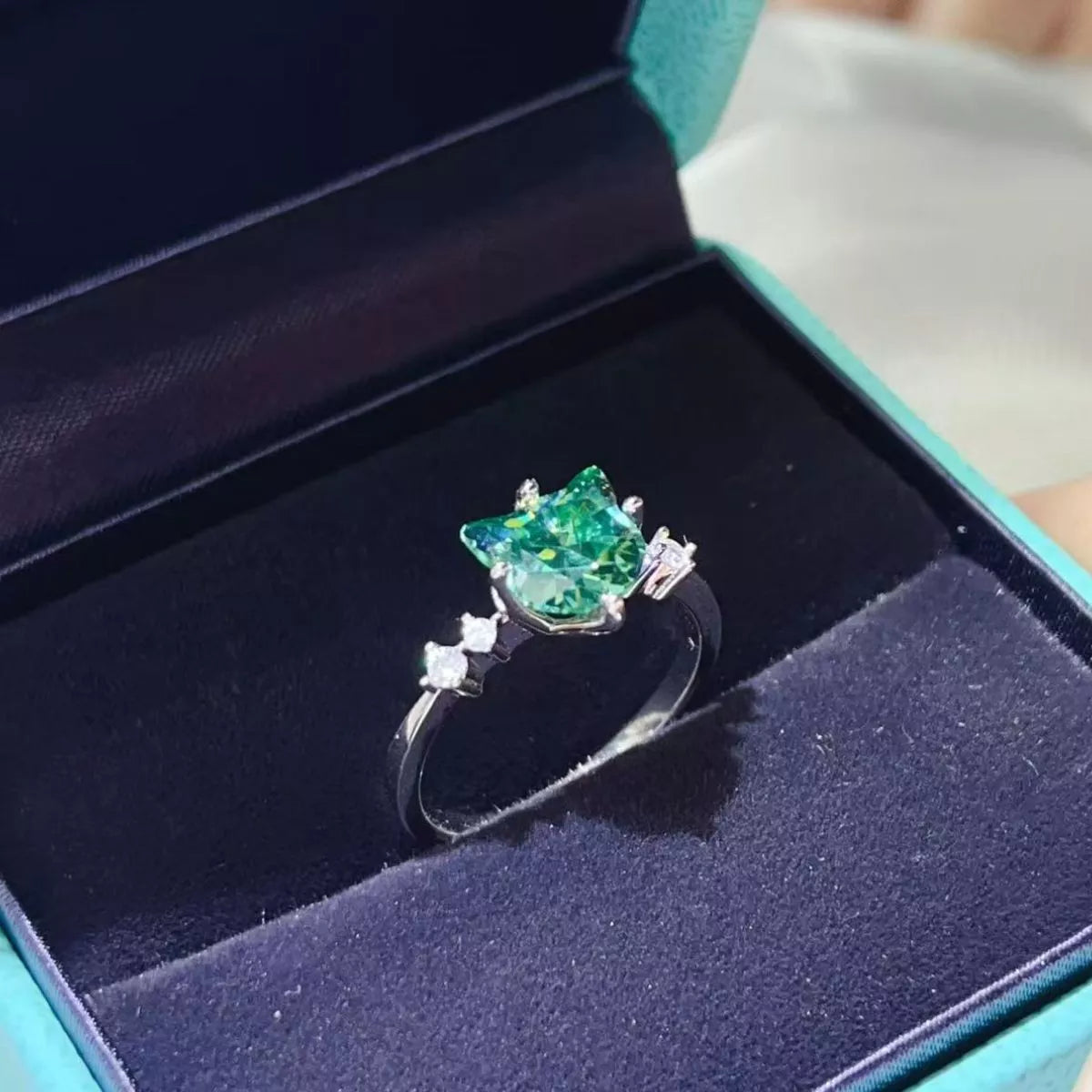 2 carat cat-shaped moissanite ring in a platinum-plated 925 sterling silver setting.