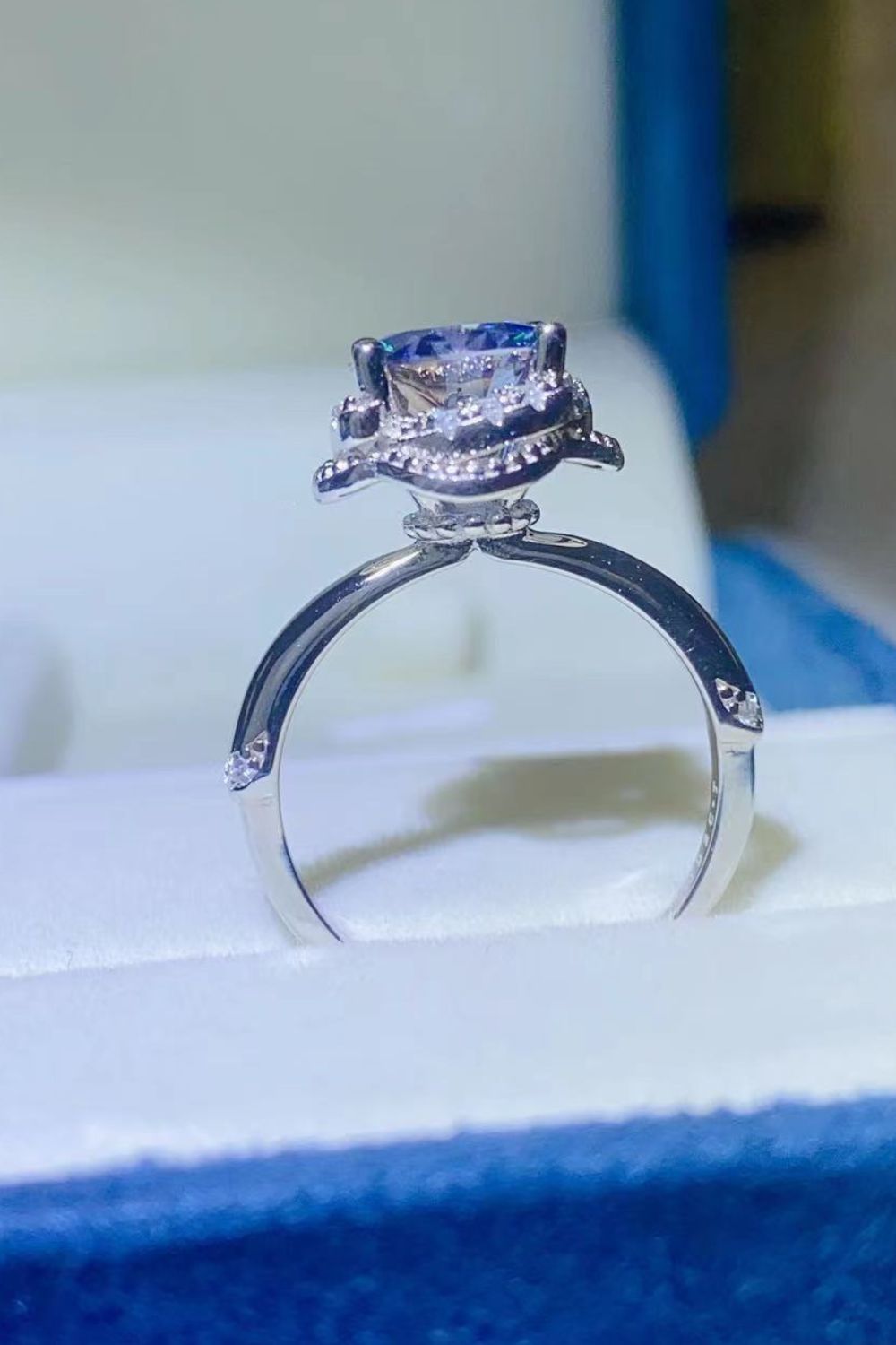 2-carat round cut moissanite solitaire ring in platinum-plated 925 sterling silver.