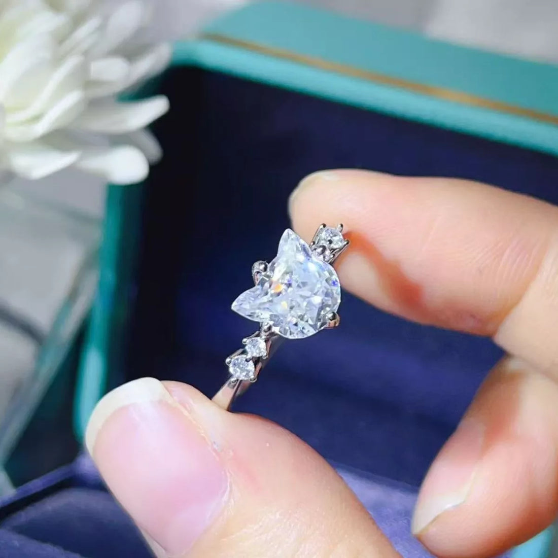 2-carat round cut moissanite solitaire ring in platinum-plated 925 sterling silver.