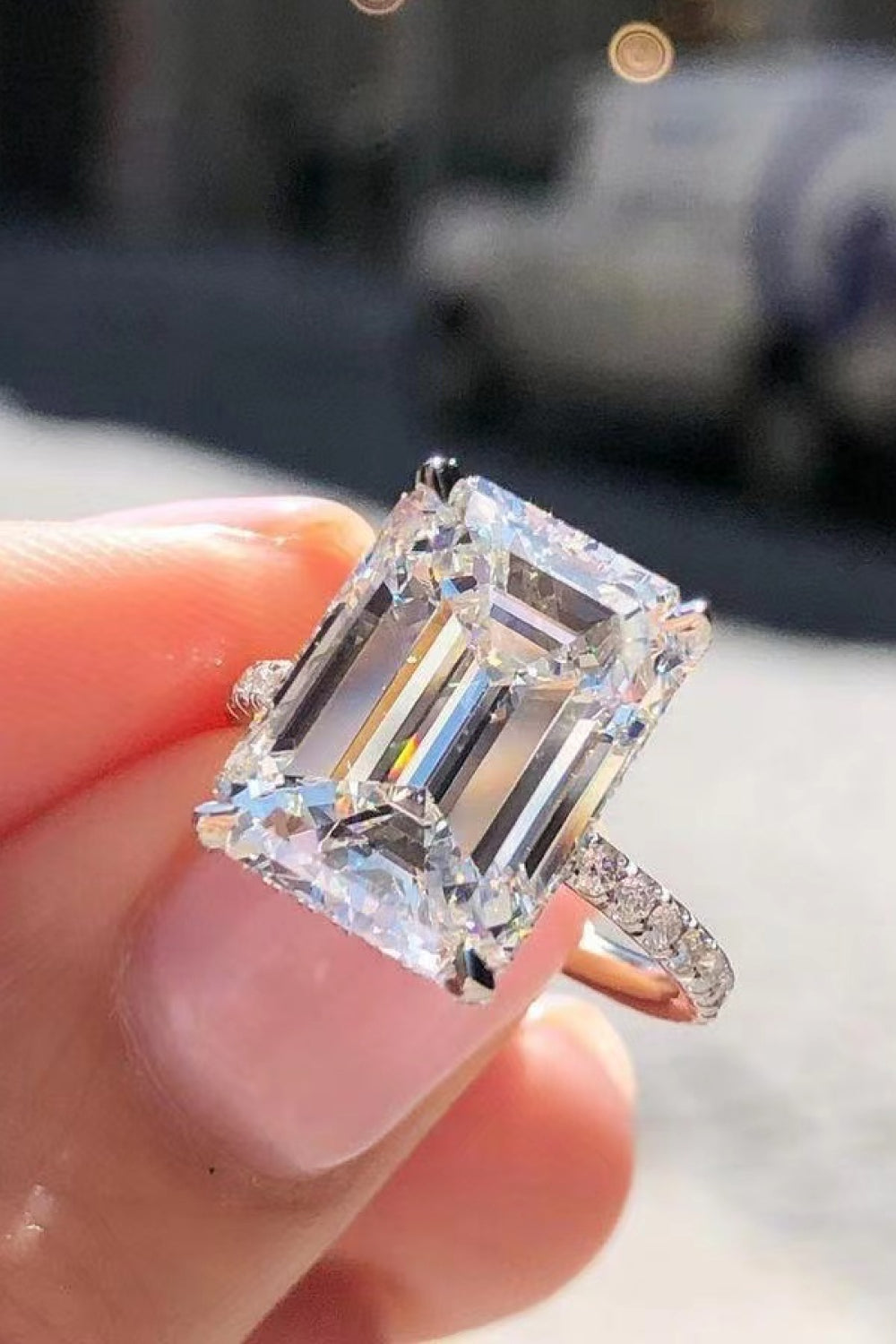5-carat round cut moissanite solitaire ring with zircon side stones in 925 sterling silver.