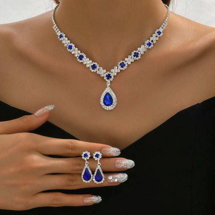 Crystal droplet necklace and matching earring set displayed on a white background.