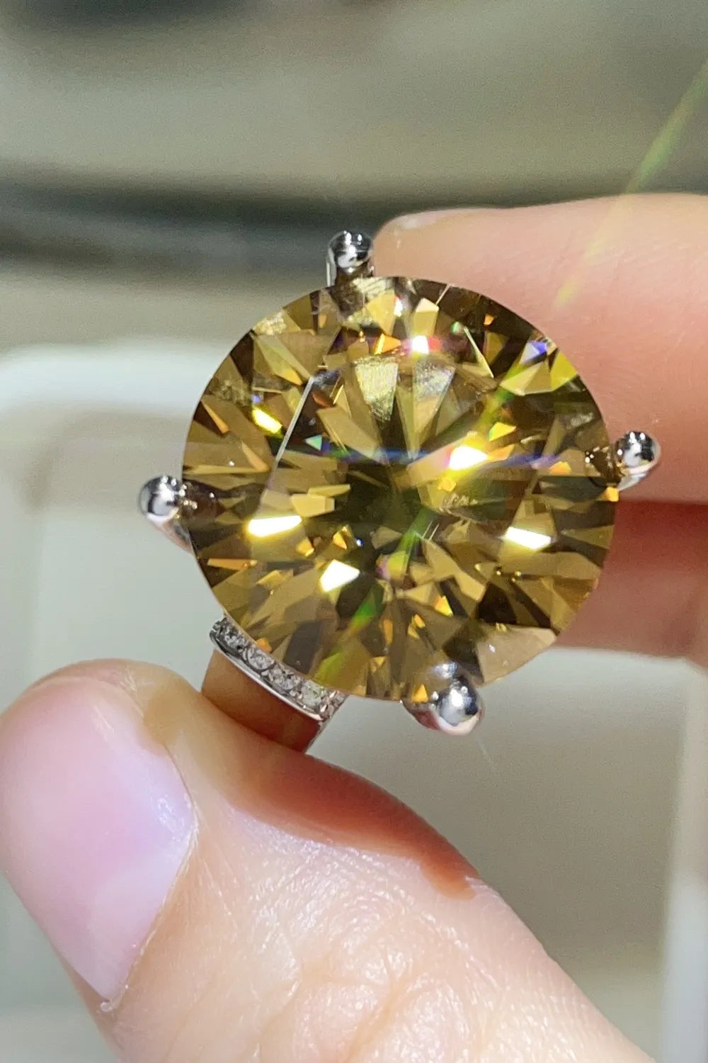 Massive 20-carat round cut moissanite solitaire ring in 925 sterling silver.