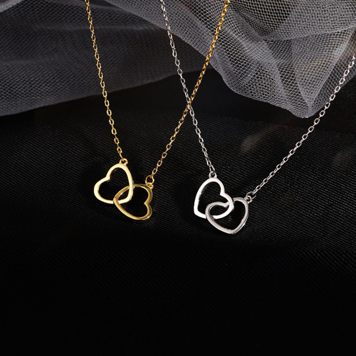 Interlocking heart pendant necklace in 18K gold plated 925 sterling silver.